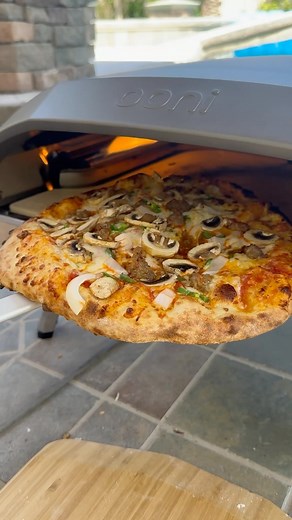 1K views · 11 reactions | Having a blast with my new Ooni pizza oven which heats up in minutes versus the monstrosity of an oven that you see behind me which takes HOURS to heat up! And the pizza the same amazing pro quality. Yum… | Top Secret Recipes | Facebook
