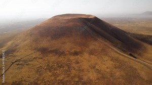 Drone rising above volcano on planet Mars. Flying towards volcanic cone on other planet. Outer space exploration and colonization concept.