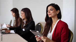Beautiful businesswoman and her female business partners on a business conference