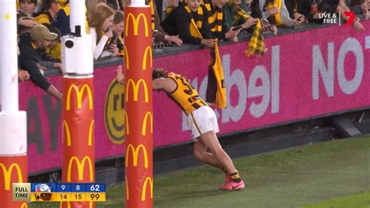 Nick Watson cramps up during Hawthorn celebrations