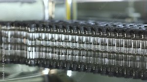 Lyophilizer with lot of liquid vaccine medicine filled glass injection vials entering into lyophilization chamber for freeze drying process in a medicine manufacturing factory injectable