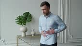 Unhealthy man suffering with stomach pain, feeling unwell Man has...