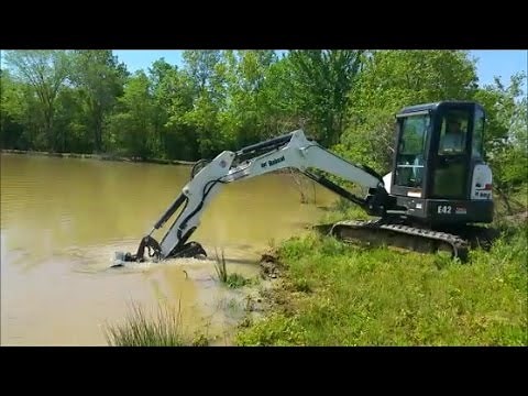Digging Deep fishing hole along shore in Farm Pond-Bobcat E42 excavator
