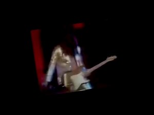 Tommy Bolin and the James Gang - Standing in The Rain from Don Kirshner's Rock Concert This is one of my favorite songs that Tommy wrote that wound up being on James Gang Bang. He wrote both the music and the lyrics in Boulder in 1973 and a demo was recorded and we produced a video for that as well, although we didn’t produce this video! How anybody who puts it out there that they like Tommy ￼couldn’t love this song to me means they have shitty ears for music and they’re just throwing darts at t