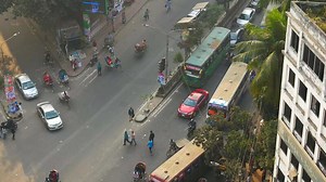 Download A busy street with cars, buses and people for free