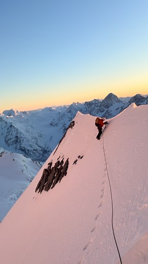 Aoraki’s East Ridge at dawn. We climbed like this for hours, protected by: ice screws, being on opposite side of the ridge, looping the rope under cornices, the occasional picket, and most important not falling off. @britishmountainguides @ifmgaofficial @wanakamountainguides | Tom Ripley