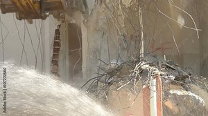 Video of excavator as a demolition machinery taking down a building