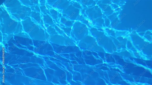 Sunlight shines brightly on the rippling surface of a swimming pool, creating captivating patterns that cast shimmering reflections and refractions on the textured blue pool floor