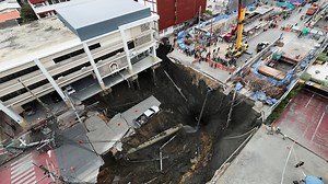 Dramatic footage shows sinkhole swallowing up road in central Bangkok