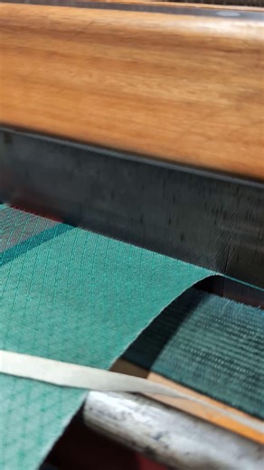 'A Woven Warning' truly demonstrates the power the weft has in determining the final appearance of a woven cloth. For this project, we have chosen to weave a variety of colourways, experimenting with combinations of warp design and bright weft threads. It is mesmerising to watch our looms in motion, as the shafts repeatedly create openings between the top shed (yarns that are raised) and the bottom shed (yarns that are not raised). This allows the shuttle to pass through the warp, interlacing th