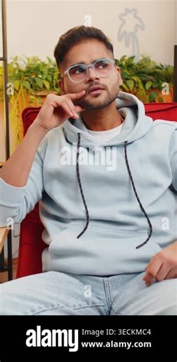 Eureka. Thoughtful clever inspired Indian man make gesture raises finger came up with creative plan feels excited with good idea inspiration motivation question at home apartment. Guy sits on chair Stock Video Footage - Alamy