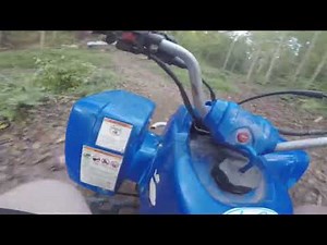 Four wheeler yamaha blaster 200 trail riding through the mud and woods