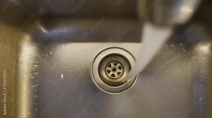 water pouring from a faucet tap slow motion