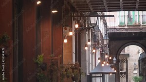 Beautiful decorative light bulbs hanging in narrow european street in the histirical ancient part of Barcelona city. Smooth camera tracking shoot.
