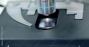 Video of microscope lens is approaching to the subject glass where the explore sample at laboratory, concept science and technology