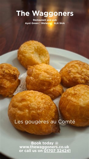 The Waggoners Ayot Green | French Restaurant & Pub on Instagram: "Les Gougères au Comté — A Little Bite of Burgundy at The Waggoners Golden, airy, and impossibly moreish — our gougères au comté have arrived on the menu. These delicate cheese puffs trace their roots back to 18th‑century Burgundy, where they were traditionally served during wine tastings… and it’s easy to see why. Light, warm, and full of character, they’re the kind of snack that disappears faster than you expect. Enjoy them at th