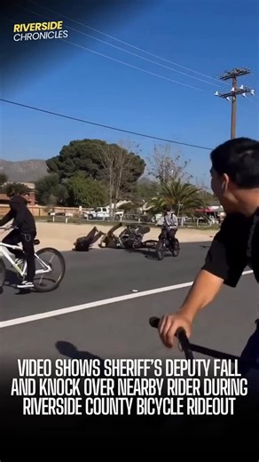 Riverside California News on Instagram: "Video shared with us shows what appears to be an accidental collision during a large end-of-year bicycle rideout in Riverside County that one rider injured. Footage shows a sheriff’s deputy riding alongside the group when the deputy appears to lose balance and fall while traveling next to a bicyclist. As the deputy goes down, he makes contact with the rider beside him, knocking that rider off their bike as well. The rider who was struck appears to have be