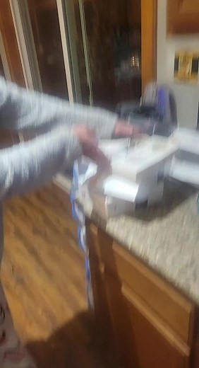 Unboxing a Black and Silver Coffee Machine in Kitchen