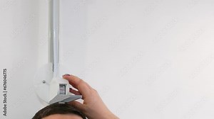 in the clinic with a professional stadiometer, the doctor measures the height of a dark-voiced man unrecognizable people measure the height of a persons height close-up space for text