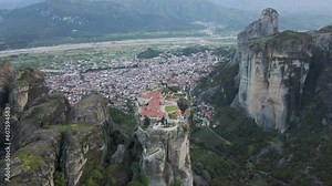 Aerial view of The Holy Trinity Orthodox Monastery with Kalabaka town in background, Meteora, Kalabaka, Thessaly, Greece.