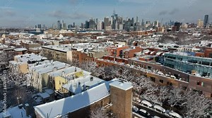 Flying backwards over snowy Carroll Gardens Brooklyn away from NYC skyline