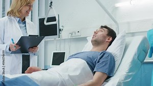 Friendly Female Doctor Visits Smiling Recovering Man who is Lying in Bed, She Asks Him Questions and Fills Medical Chart, Nurse Checks His Vital Signs.