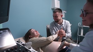 Free stock video - Pregnant woman having ultrasound scan at the gynecologist office while loving husband holding her hand 7
