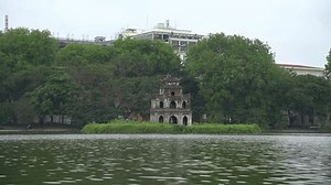 Hoan Kiem Lake ( Ho Guom) or Sword lake in the center of Hanoi in the fog in the morning. Hoan Kiem Lake is a famous tourist place in Hanoi. Travel and landscape concept.