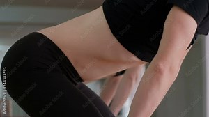 Close-up. Athletic girl holds her breath. Fitness exercise to strengthen the abdominals. Bodyflex. Lifestyle Sports and health.