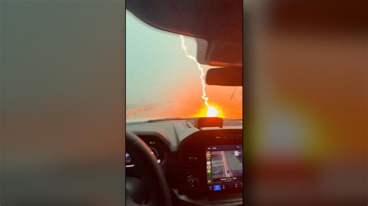 Powerful lightning strike creates sparks on car's hood during storm: See the video