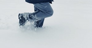 clip-3428209061-hiker-walking-deep-snow-outdoors-forest-landscape