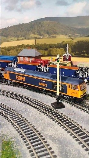 Class 60 with Hopper and Seacow wagons. Model railway running.