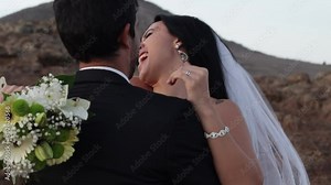 Newly wedded bride & groom hugging kissing caressing each other on their wedding day at sunset outdoors at seaside location celebrating love wedding photoshoot bouquet happiness neck bite married