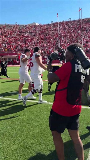 IU President Pamela Whitten shares a celebratory hug with DT Mario Landino after Nebraska win