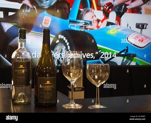 Andretti Winery wine display with video imagery of Mario Andretti in background at the Indianapolis Motor Speedway Museum, Indiana, July 28, 2019, © K Stock Photo - Alamy