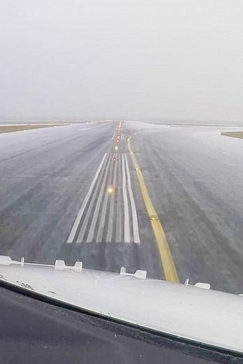 Winter Landing: Airplane Touches Down on Snow-Covered Runway