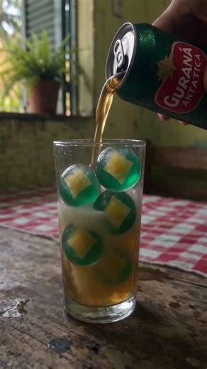 brazilian soda (guaraná antarctica) over ice balls gentle pour