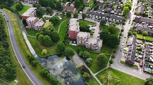 Download Aerial view of residential area with a river and a road for free