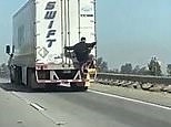 Man hitches a ride down Californian highway holding the back of a truck