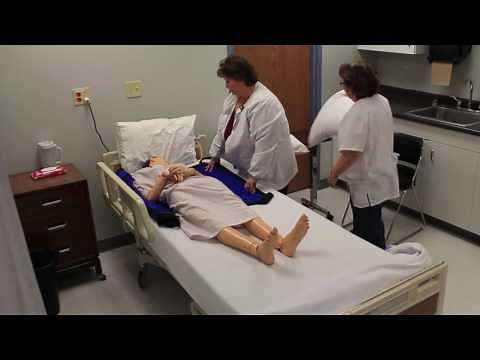 Moving a dependent resident up in bed and logrolling a resident using a turn sheet