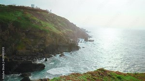 National Trust - Lizard Point, Cornwall, England, a scenic Rocky coastline in 4K. Seagulls flying over British scenic rocky cliffs with a walking path, the most Southern point of England's mainland.