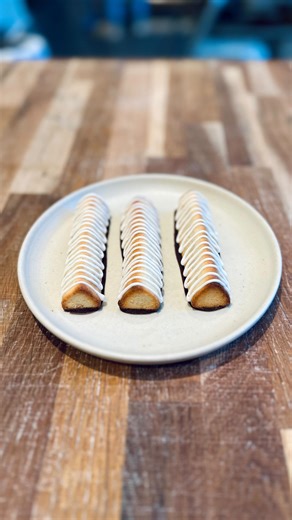 Kransekage for New Year’s 🥂 A Danish New Year’s Eve classic. Our kransekage is made with marzipan, hints of lemon, topped with icing, and dipped in dark chocolate — the perfect way to welcome the new year on a sweet note. Available for pre-order (via link in bio). Get yours for this year’s New Year’s celebration at Andersen & Maillard in Nordhavn. #andersenmaillard #kransekage #NewYearseve #nytårsaften | Andersen & Maillard