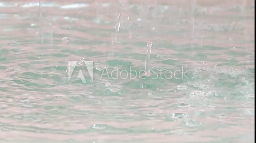 Slow motion closeup of summer heavy rain drops falling into puddles on asphalt, Rain splashes hit the asphalt, heavy rain, close-up
