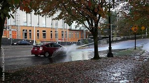 Slow Motion of cars driving through a puddle of water in Portland, Oregon