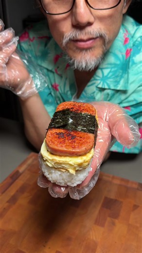 Making spam musubi Recipe: 1. Rice Cook 300g rice with 320g water. Season with a pinch of salt and sesame oil. 2. Egg Omelet Beat 3 eggs with salt. Fry it into a flat omelet. Tip: Use the empty Spam can to cut the omelet into a perfect shape. 3. Spam & Assembly Slice and grill the Spam. Brush one side with teriyaki sauce. Line the empty Spam can with plastic wrap and place a seaweed (Nori) strip inside. Press 4 spoonfuls of rice into the bottom. Layer the egg omelet, then add another layer of ri