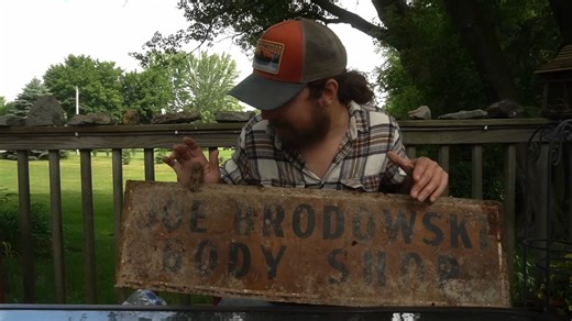 A river treasure hunt turned up a double-sided body shop sign from another era