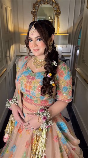 Amana Rahman Bespoke Makeup on Instagram: "Peachy tones on the eyes, cheeks and lips with pop of colors on the eyes to bring out the whole look and match it with the bride’s beautiful lehenga ✨ #holudbride"