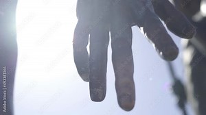 Sculpture open hand close up with sunshine passing through open finger, mystical vision emotional faithful concept in slow motion close up