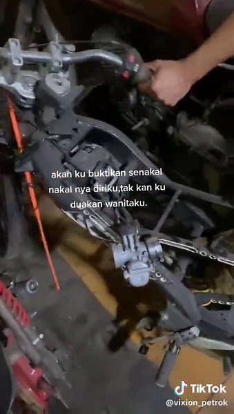 Motorcycle Exhaust System Adjustment in a Garage