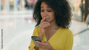 African american unhappy woman looking at screen mobile phone smartphone bad news loss failure frowning upset girl female electronic gadget problem difficulty trouble mistake stress frustration sad